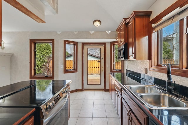 11228 River Rd, Champlin, MN 55316 - kitchen with appliances with stainless steel finishes, healthy amount of natural light, light tile patterned flooring, tasteful backsplash, and lofted ceiling