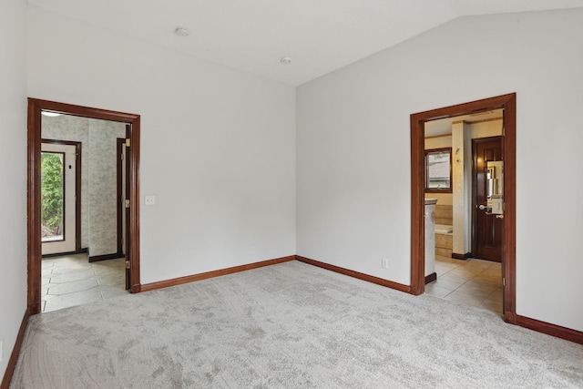 11228 River Rd, Champlin, MN 55316 - carpeted empty room featuring tile patterned floors and vaulted ceiling