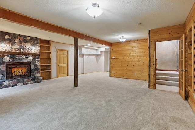 11228 River Rd, Champlin, MN 55316 - finished below grade area with carpet, a textured ceiling, wooden walls, and a stone fireplace