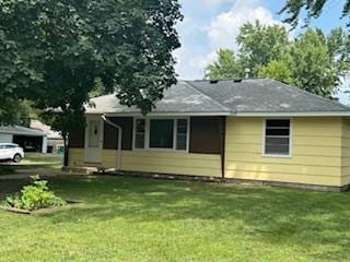 11721 Olive St NW, Coon Rapids, MN 55448 - rear view of house featuring a lawn