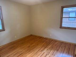 11721 Olive St NW, Coon Rapids, MN 55448 - spare room with light wood-style flooring and baseboards