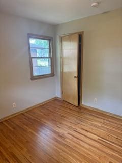 11721 Olive St NW, Coon Rapids, MN 55448 - unfurnished room featuring wood finished floors and a smoke detector