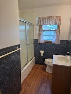 11721 Olive St NW, Coon Rapids, MN 55448 - full bath with vanity, wood finished floors, and tile walls