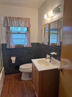 11721 Olive St NW, Coon Rapids, MN 55448 - full bath with vanity, wood finished floors, a baseboard radiator, and tile walls