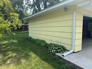 11721 Olive St NW, Coon Rapids, MN 55448 - view of property exterior with a lawn
