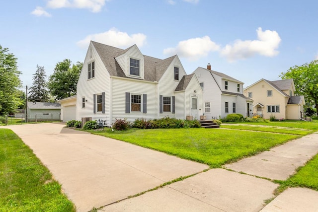 215 Plainview St, Owatonna, MN 55060 - cape cod home with concrete driveway, a garage, and roof with shingles