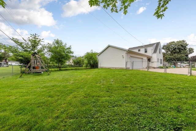 215 Plainview St, Owatonna, MN 55060 - view of yard with a garage, a playground, and concrete driveway