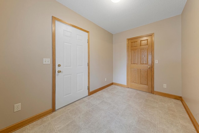 215 Plainview St, Owatonna, MN 55060 - spare room with baseboards and a textured ceiling