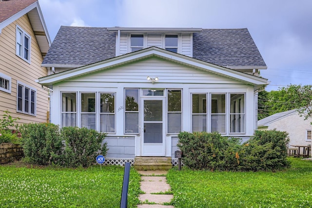 1826 Case Ave E, Saint Paul, MN 55119 - bungalow-style house with a sunroom, a shingled roof, entry steps, and a front lawn