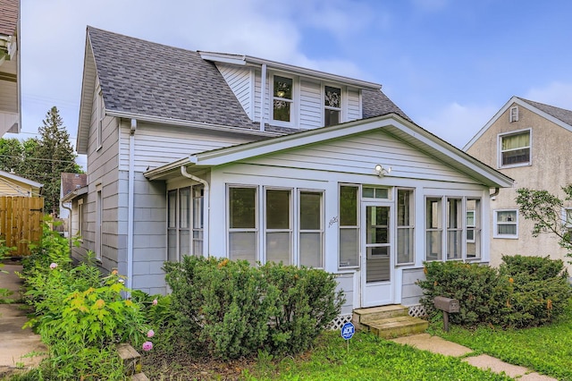 1826 Case Ave E, Saint Paul, MN 55119 - view of front facade featuring entry steps, roof with shingles, and a sunroom