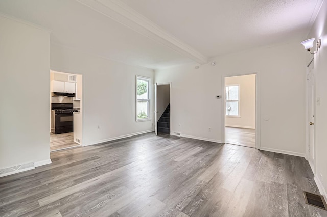 1826 Case Ave E, Saint Paul, MN 55119 - unfurnished living room featuring wood finished floors, stairs, crown molding, and beamed ceiling