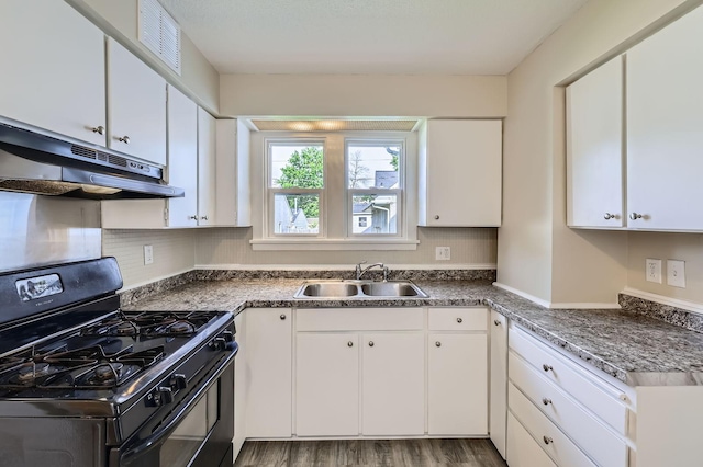 1826 Case Ave E, Saint Paul, MN 55119 - kitchen with black gas stove, under cabinet range hood, white cabinets, and tasteful backsplash