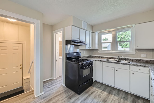 1826 Case Ave E, Saint Paul, MN 55119 - kitchen featuring black gas stove, under cabinet range hood, light wood-style flooring, white cabinets, and a textured ceiling