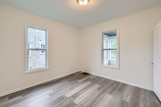 1826 Case Ave E, Saint Paul, MN 55119 - spare room with wood finished floors, crown molding, and a textured ceiling