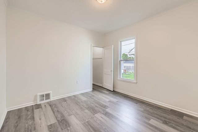 1826 Case Ave E, Saint Paul, MN 55119 - spare room with wood finished floors and crown molding