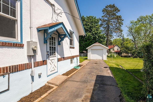 1718 Dunedin Ave, Duluth, MN 55803 - view of side of home with driveway, stucco siding, a garage, and an outdoor structure