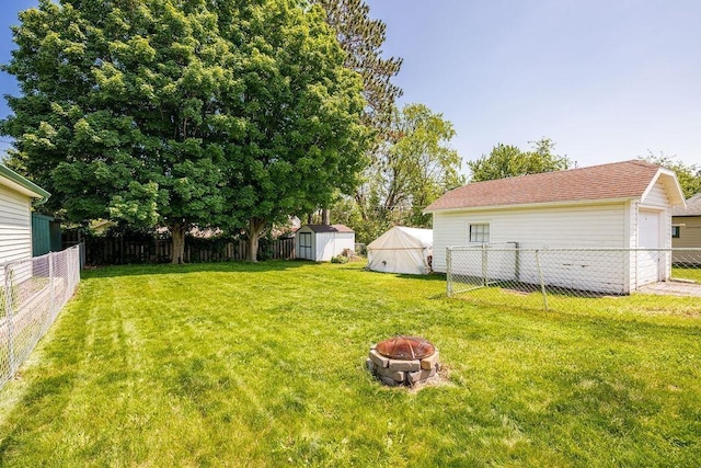 1718 Dunedin Ave, Duluth, MN 55803 - fenced backyard with an outdoor fire pit and a storage unit