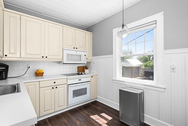 1718 Dunedin Ave, Duluth, MN 55803 - kitchen with white appliances, dark wood-type flooring, light countertops, a wainscoted wall, and decorative light fixtures