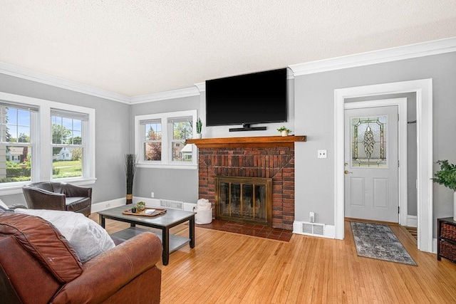 1718 Dunedin Ave, Duluth, MN 55803 - living area featuring light wood-style floors, a fireplace, crown molding, and a textured ceiling