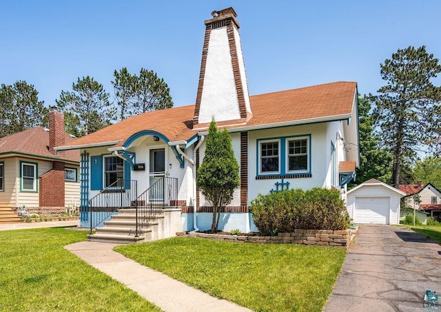 1718 Dunedin Ave, Duluth, MN 55803 - bungalow-style home with a chimney, a garage, an outbuilding, and stucco siding