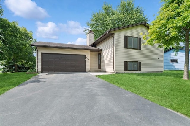 8983 Vinewood Ln N, Maple Grove, MN 55369 - split level home featuring asphalt driveway, a garage, a front yard, and a chimney