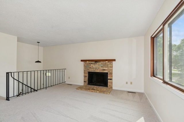 8983 Vinewood Ln N, Maple Grove, MN 55369 - unfurnished living room featuring carpet, a textured ceiling, and a brick fireplace