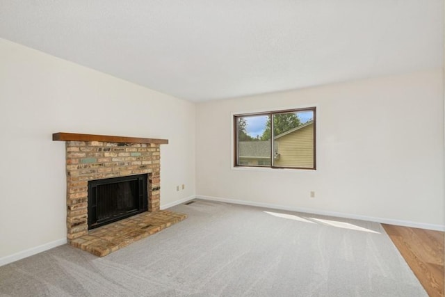 8983 Vinewood Ln N, Maple Grove, MN 55369 - unfurnished living room featuring a fireplace and carpet floors