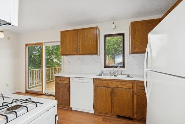 8983 Vinewood Ln N, Maple Grove, MN 55369 - kitchen featuring white appliances, plenty of natural light, light countertops, and decorative backsplash