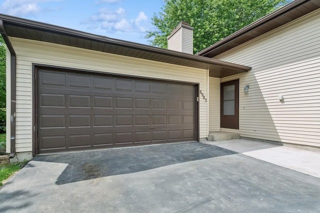 8983 Vinewood Ln N, Maple Grove, MN 55369 - garage featuring driveway