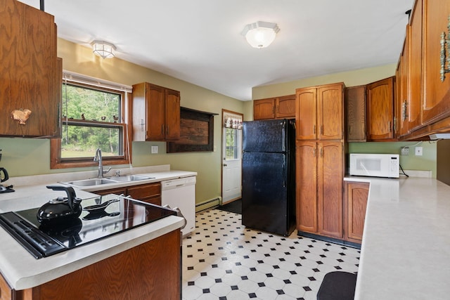 18400 Lundgren Dr, Pine Lake Twp, MN 55735 - kitchen featuring black appliances, a baseboard heating unit, light countertops, and light flooring