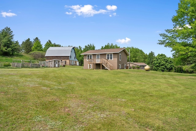18400 Lundgren Dr, Pine Lake Twp, MN 55735 - view of grassy yard featuring a barn, stairs, an outbuilding, and a deck