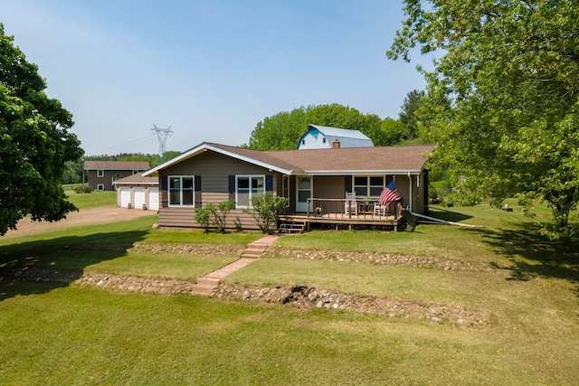 18400 Lundgren Dr, Pine Lake Twp, MN 55735 - ranch-style house featuring a front yard, an outbuilding, a garage, and covered porch