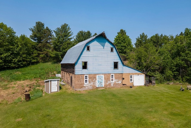 18400 Lundgren Dr, Pine Lake Twp, MN 55735 - back of house featuring a barn, a gambrel roof, an outbuilding, and a yard