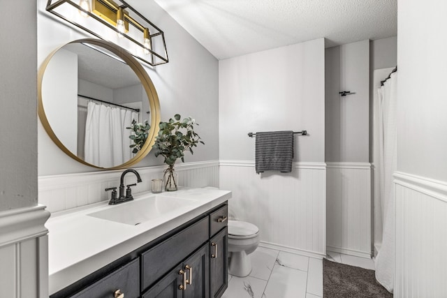 5830 Forest Boulevard Trl, Wyoming, MN 55092 - bathroom with wainscoting, vanity, marble finish floors, and a textured ceiling