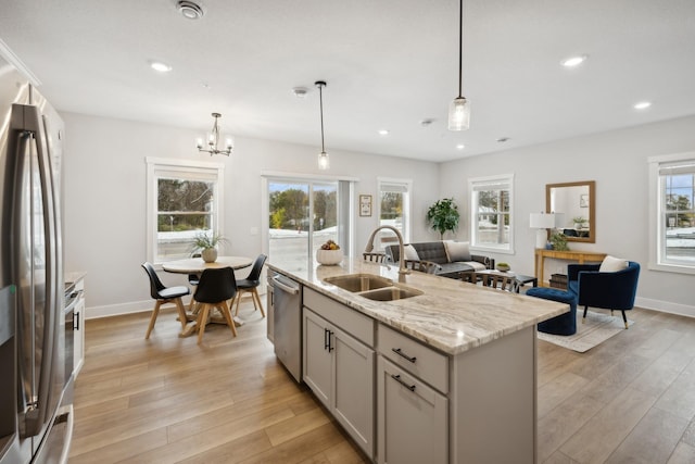 3401 Douglas Dr N, Crystal, MN 55422 - kitchen with appliances with stainless steel finishes, light wood-type flooring, a chandelier, an island with sink, and recessed lighting