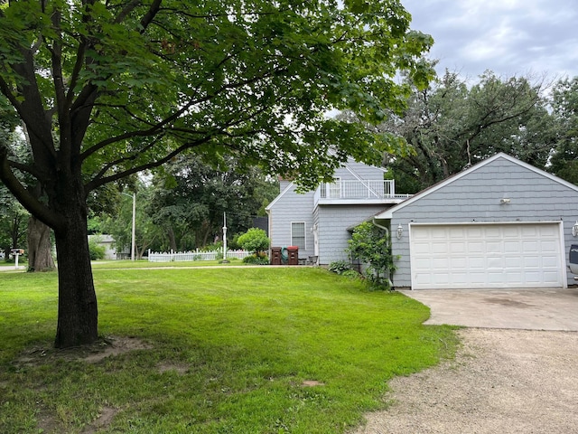 1401 2nd Ave, Newport, MN 55055 - view of green lawn featuring concrete driveway, a balcony, and an attached garage