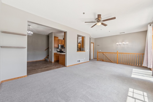 886 Coon Rapids Boulevard Extension NW, Coon Rapids, MN 55433 - unfurnished living room featuring light colored carpet, a chandelier, and a ceiling fan