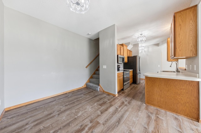 886 Coon Rapids Boulevard Extension NW, Coon Rapids, MN 55433 - kitchen featuring stainless steel appliances, light wood-style flooring, and light countertops