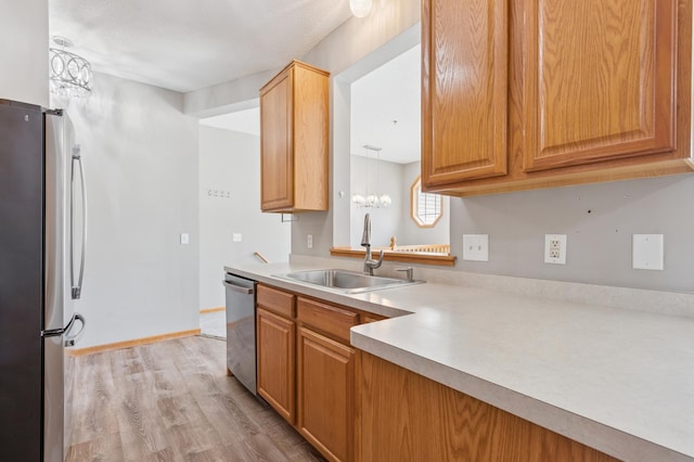 886 Coon Rapids Boulevard Extension NW, Coon Rapids, MN 55433 - kitchen featuring stainless steel appliances, light wood-type flooring, and light countertops