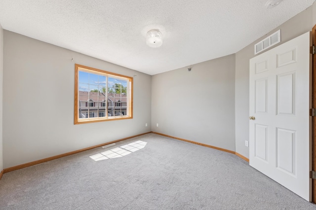 886 Coon Rapids Boulevard Extension NW, Coon Rapids, MN 55433 - carpeted empty room featuring baseboards and a textured ceiling
