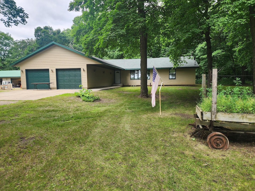 28029 620th Ave, Compton Twp, MN 56482 - single story home featuring a garage, driveway, a front lawn, and a garden