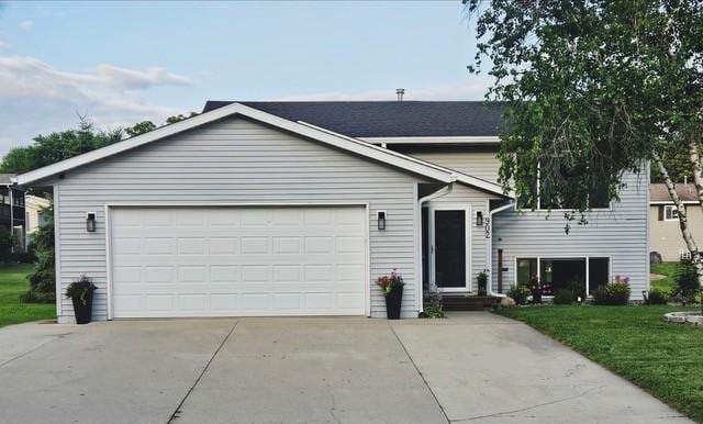 902 Burr Oak Ave NE, Chatfield, MN 55923 - view of front of property featuring a front yard, concrete driveway, and an attached garage