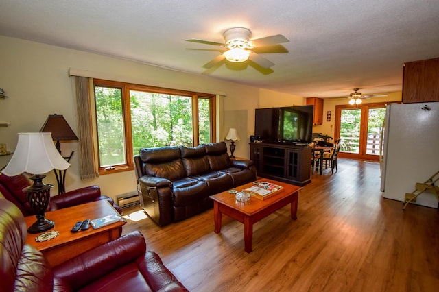 31879 US-71, Park Rapids, MN 56470 - living area featuring a ceiling fan, wood finished floors, and a baseboard radiator