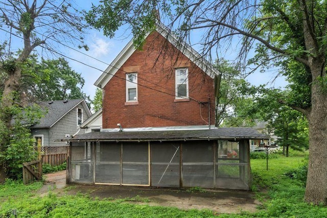 697 Tuscarora Ave, Saint Paul, MN 55102 - rear view of house featuring a sunroom and brick siding
