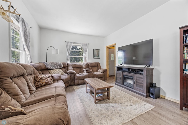 1035 University Dr N, Fargo, ND 58102 - living room featuring light wood finished floors and a glass covered fireplace