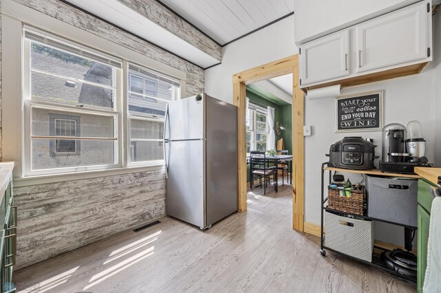 1035 University Dr N, Fargo, ND 58102 - kitchen featuring freestanding refrigerator, light wood-style floors, white cabinetry, and light countertops