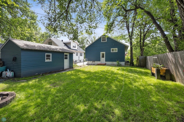 1035 University Dr N, Fargo, ND 58102 - rear view of property with a fenced backyard and an outbuilding