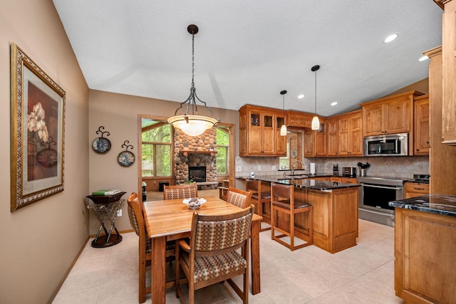 2520 Florida Ave N, Golden Valley, MN 55427 - dining space with light tile patterned flooring, a stone fireplace, and recessed lighting