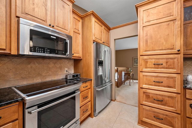 2520 Florida Ave N, Golden Valley, MN 55427 - kitchen featuring stainless steel appliances, backsplash, light tile patterned flooring, and light colored carpet