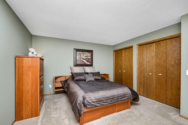 2520 Florida Ave N, Golden Valley, MN 55427 - bedroom featuring multiple closets, light colored carpet, and a textured ceiling